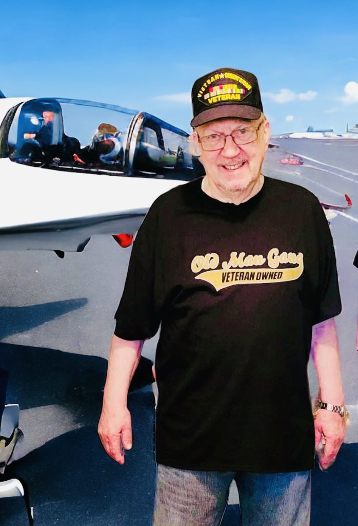 A man standing in front of an airplane.