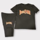 A black t-shirt and pants with the words " dueling drums ".