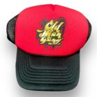 A red and black hat with graffiti on it